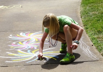 Child making chalk art